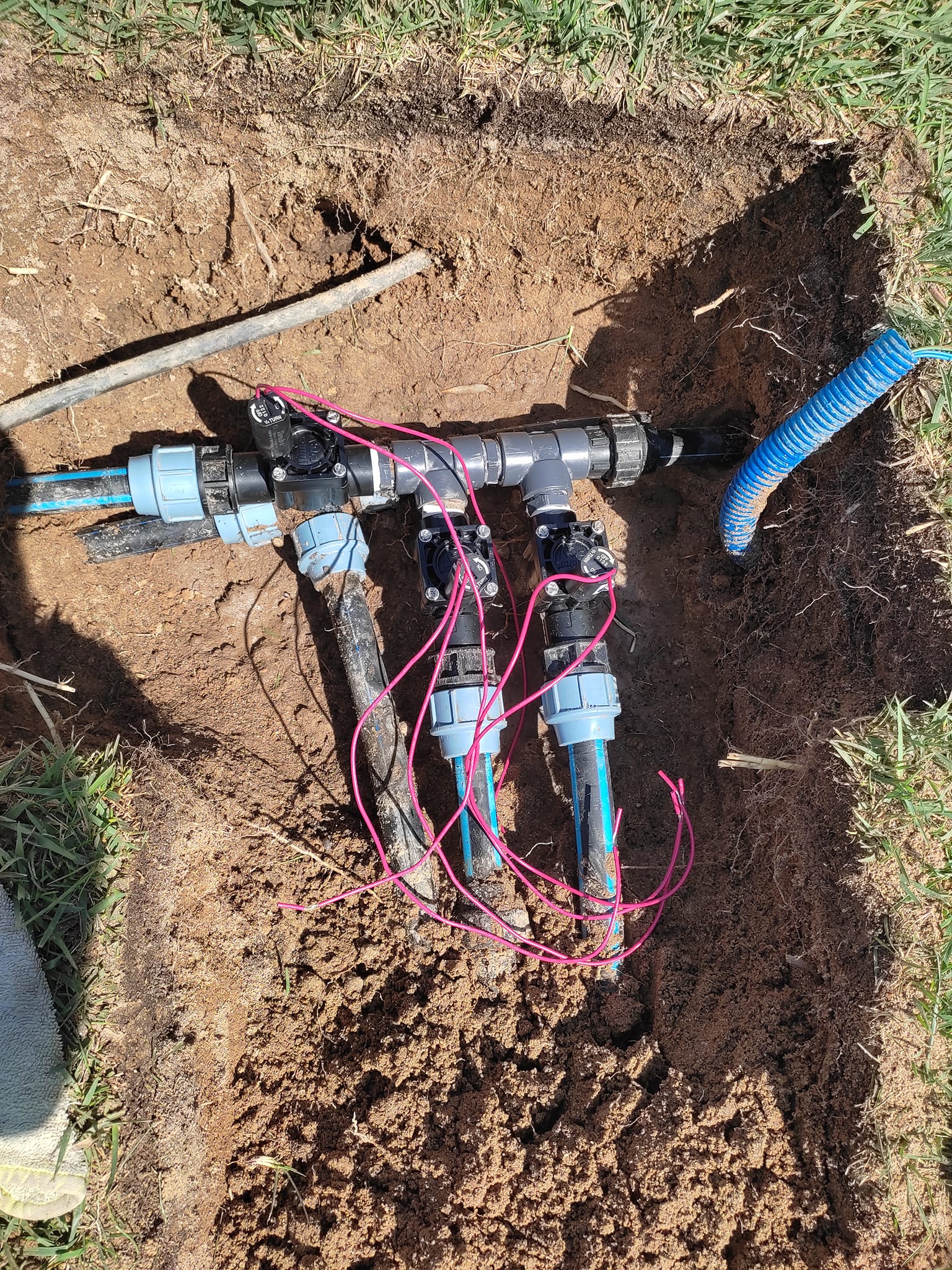Sistema de rega instalado em vala, com válvulas e tubagem